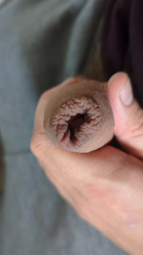 Pulling back the foreskin and showing the head