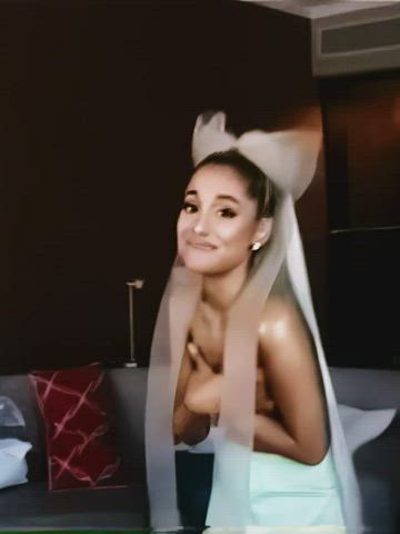 Ariana Grande holding her titties