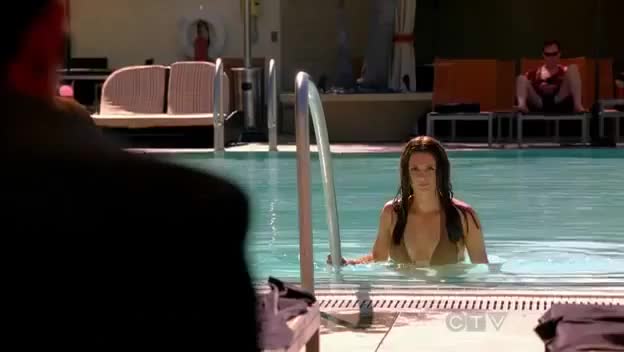 Stana Katic getting of a pool