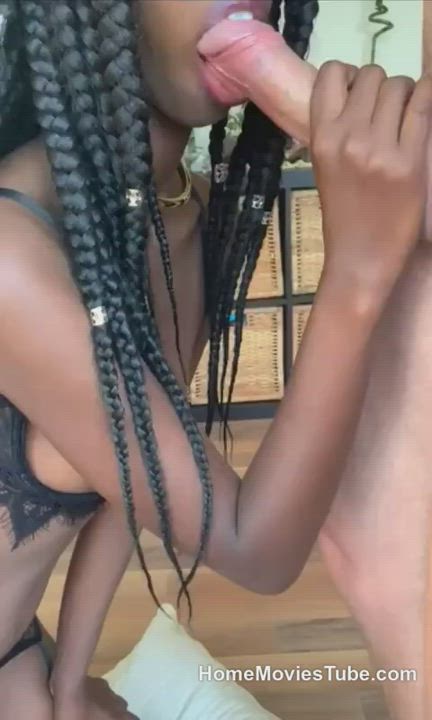 Ebony in braided dreadlocks licking cock like a lollipop.
